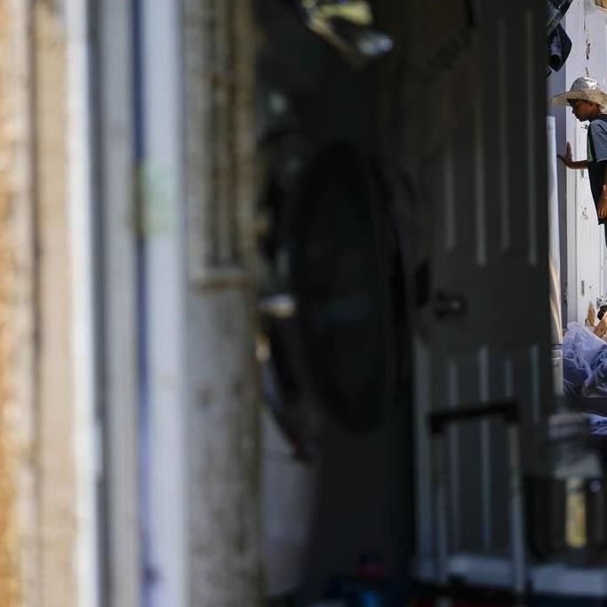 In a north Texas county, dazed residents sift through homes mangled by a tornado